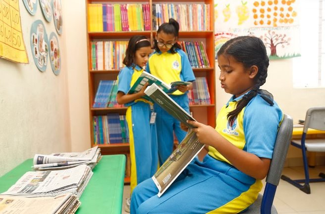 Royal Concorde students reading and choosing books in the school reading room